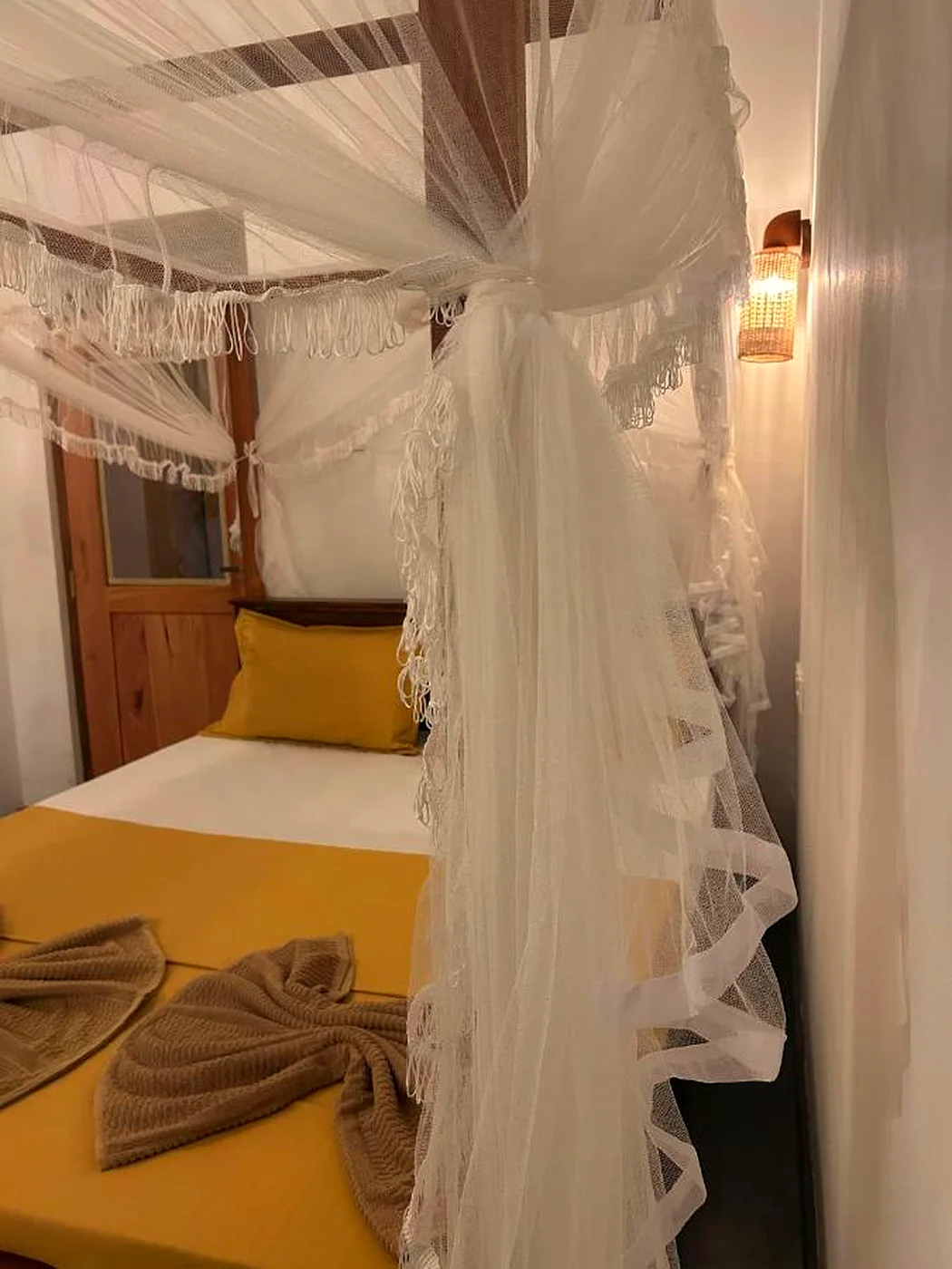 A double bed under a mosquito net